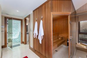 a bathroom with wooden walls and a shower with towels at Property 434 - Oughterard in Oughterard