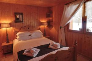 1 dormitorio con 1 cama con 2 toallas en Chalet Les Grolets - Ardent en Montriond