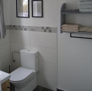 a white bathroom with a toilet and some towels at Marla in Lauterbach