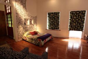 a bedroom with a bed in the middle of a room at Patrimonial redesigned luminous loft for couples in Valparaíso