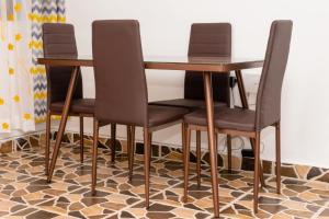 a table and four chairs on a hexagonal floor at Powerground Resort in Nairobi
