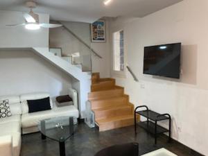 a living room with a couch and a flat screen tv at ESLORA in Platja  d'Aro