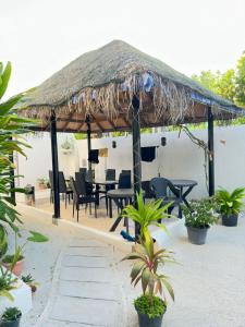 a gazebo with chairs and a table and chairs at AHI Maldives in Omadhoo