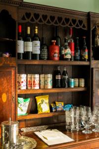 a cabinet filled with lots of bottles of alcohol at Plas Dolguog in Machynlleth