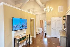 a living room with a flat screen tv on a wall at Haven at Hazel~Downtown Bungalow in Demorest