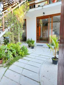 a walkway in front of a building with plants at AHI Maldives in Omadhoo
