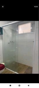 a glass shower in a bathroom with a window at Apartamento centro in São Paulo