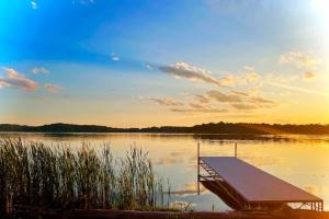 un quai au milieu d'un lac au coucher du soleil dans l'établissement Studio Cottage Lake and Beach, à Clitherall 13 autres photos