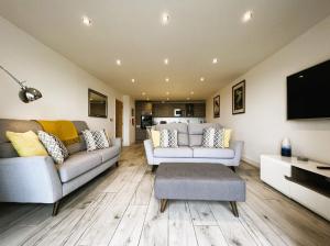 a living room with two couches and a tv at The Beach Retreat - Pet Friendly in Sandown