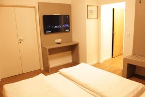 Postel nebo postele na pokoji v ubytování Isar City Hotel