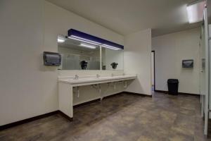 a bathroom with a sink and a large mirror at Escape to Nature and Lake views Studio Style Rooms in Clitherall