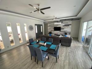 een woonkamer met een tafel en een bank bij Playa Potrero - modern 3 BR home centrally located - Casa Coastal Serenity in Guanacaste