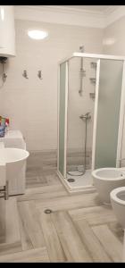 a bathroom with a shower and a toilet and a sink at Saranda centre apt in Sarandë