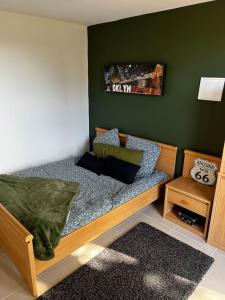 Bett in einem Zimmer mit grüner Wand in der Unterkunft La villa Rosa in Bédoin