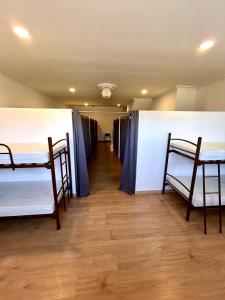 a room with two bunk beds and a hallway at Albergue Melide in Melide