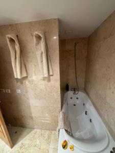 a bathroom with a white tub and a shower at Ático El Reducto views in Arrecife