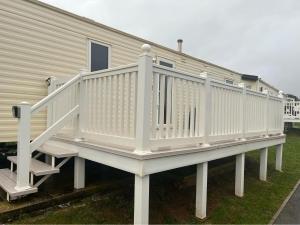a white deck on a house with stairs at Devon Cliffs Holiday Park - Haven, 3 Bed - ABI Horizon - Wi Fi in Exmouth