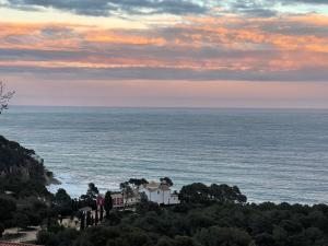 a house on a hill next to the ocean at SeaHomes Vacations, LA CASA BLUE Mediterranean Lifestyle in Blanes