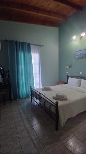 a large bed in a room with a window at AGNANTIO in Monemvasia