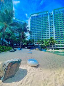 a frisbee on a sandy beach with a building at Staycation in the Corner by MJJ in Manila