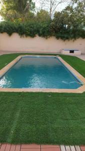 a swimming pool in the middle of a yard at Villa Room #6 in Umm Al Sheif in Dubai
