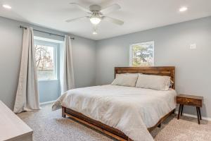 a bedroom with a bed and a ceiling fan at Spacious Arkansas Retreat with Deck, Hot Tub and Grill in Rogers