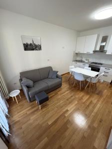 a living room with a couch and a table at Forli Sud - Romagna Central Suite Apartment - Parking in Forlì