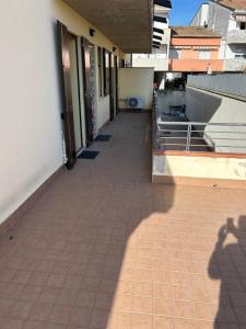 a shadow of a person walking down a sidewalk at Forli Sud - Romagna Central Suite Apartment - Parking in Forlì