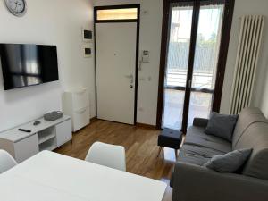 a living room with a couch and a tv at Forli Sud - Romagna Central Suite Apartment - Parking in Forlì