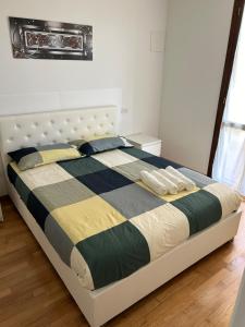 a bedroom with a bed with a black and yellow comforter at Forli Sud - Romagna Central Suite Apartment - Parking in Forlì