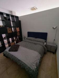 a bedroom with a bed with a black headboard at Appartamento Loft in Turin