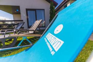 a group of lawn chairs sitting in front of a house at Bursztyn II Domki Apartamenty Pokoje w Sarbinowie blisko morza in Sarbinowo