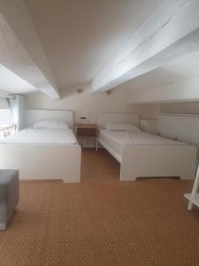 a room with two beds and a table and a bedsenalsenalsenalsenalsenal at Open-plan T2 with sea view in La Croix-Valmer