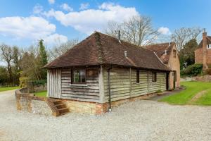 a small house is sitting on a gravel road at Byre in Herstmonceux