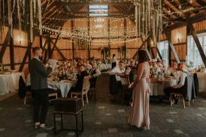 a bride and groom at their wedding reception in a barn at Brīvdienu māja "Avotiņš" in Līvāni