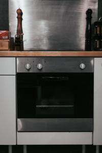a stove top oven in a kitchen with a counter at Nid douillet - Elégant studio en plein centre de Riom in Riom