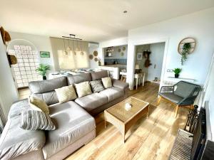 a living room with a couch and a table at SeaHomes Vacations, LA CASA BLUE Mediterranean Lifestyle in Blanes