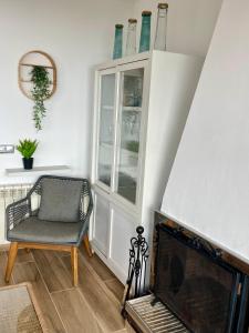a living room with a chair and a fireplace at SeaHomes Vacations, LA CASA BLUE Mediterranean Lifestyle in Blanes