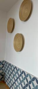 three wooden hats on a wall above a couch at SeaHomes Vacations, LA CASA BLUE Mediterranean Lifestyle in Blanes