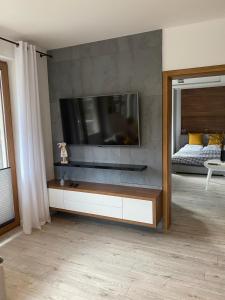 a living room with a flat screen tv on a wall at Apartament CARPANO, Ogrodnicza 7 / KARPACZ in Karpacz