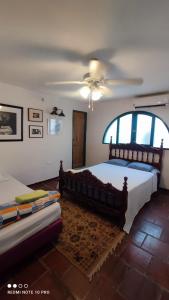 a bedroom with a bed and a ceiling fan at Casa Paula santa marta in Gaira