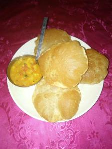 a plate of food with biscuits and a bowl of soup at India Tours only Ekanta Apan in Mathurakhanga