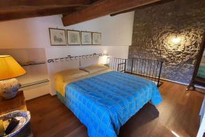 a bedroom with a bed and a stone wall at Il Cantuccio Proprietà in Pescaglia