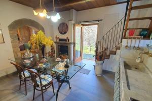 a dining room with a table and chairs and a fireplace at Il Cantuccio Proprietà in Pescaglia