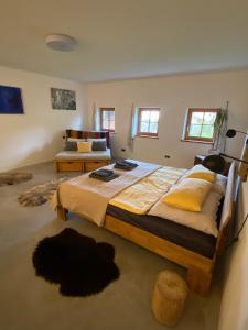 a large bedroom with a large bed and a couch at HalterHausPuch in Puch