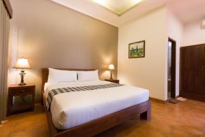 Postel nebo postele na pokoji v ubytování Vidi Boutique Hotel