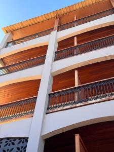 an external view of a building with wooden balconies at Hotel Caitá in Morro de São Paulo