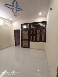 a room with a room with a wall with a fan at Adinath Residency in Jaipur