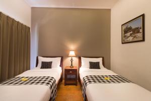 Postel nebo postele na pokoji v ubytování Vidi Boutique Hotel