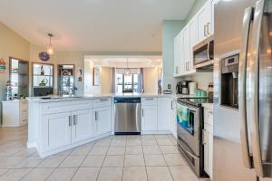 a kitchen with white cabinets and stainless steel appliances at Pet-Friendly Fort Pierce Home with Deck and Pool! in Fort Pierce